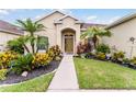 Well-maintained home with lush landscaping leading to a welcoming front entrance, perfect for curb appeal at 17843 Golden Leaf Ln, Orlando, FL 32820