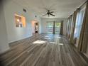 Spacious living room with wood-look floors and access to backyard at 809 Florida Pkwy, Kissimmee, FL 34743