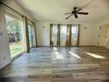 Bright living room featuring wood-look floors and sliding glass doors at 809 Florida Pkwy, Kissimmee, FL 34743