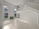 Open living room featuring high ceilings and tile floors at 340 Troon Cir, Davenport, FL 33897