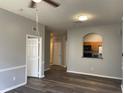 Open living room featuring a kitchen pass-through and wood-look floors at 6100 Stevenson Dr # 207, Orlando, FL 32835