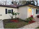 Cozy home with black shutters, landscaped garden beds, and a brick walkway leading to the front door at 1531 Wauchula St, Intercession City, FL 33848