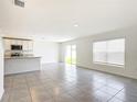 Bright living room with tile floors and sliding glass doors leading to the backyard at 5043 Sw 88Th Pl, Ocala, FL 34476