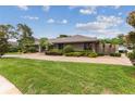 House exterior with manicured lawn and paved driveway at 9227 Cypress Cove Dr, Orlando, FL 32819