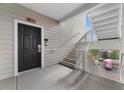 Apartment entryway with a black front door, white railings, and stairs at 3176 Feltrim Pl # 305, Kissimmee, FL 34747