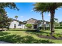 Single-story home with stone accents and palm trees at 32619 View Haven Ln, Sorrento, FL 32776