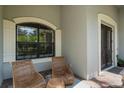 Relaxing front porch with wicker chairs and a side table at 32619 View Haven Ln, Sorrento, FL 32776