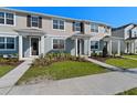 Attractive townhome exteriors with modern design, complemented by well-kept landscaping at 3205 Douglas Fir Dr, Apopka, FL 32703