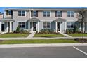 Attractive townhouse exterior featuring gray siding, dark shutters, and landscaped front yard at 3225 Douglas Fir Dr, Apopka, FL 32703
