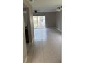 Bright living room featuring tile flooring and sliding glass doors to a patio, offering ample natural light at 2444 Summerfield Way # 1, Kissimmee, FL 34741