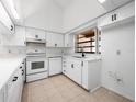 Bright kitchen featuring white cabinetry, modern appliances, and a window offering natural light at 225 Terrace Hill Blvd # 1C, Debary, FL 32713
