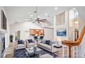 Bright, open living room with vaulted ceilings, modern furnishings, and a seamless transition to the kitchen at 33412 E Lake Joanna Dr, Eustis, FL 32736