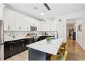 Modern kitchen featuring a large island, quartz countertops, and stainless steel appliances at 273 Willow View Dr, Davenport, FL 33896