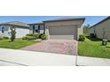Well-maintained single-story home with a brick driveway and neat landscaping at 3158 Viceroy Ct, Poinciana, FL 34759