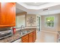 Bright kitchen featuring granite countertops, stainless steel appliances, and natural light at 524 Hockendale Cv, Sanford, FL 32771