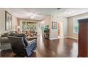 Spacious living room with hardwood floors and a screened in porch visible through sliding glass doors at 524 Hockendale Cv, Sanford, FL 32771