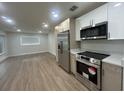 Modern kitchen featuring stainless steel appliances, sleek cabinets, and recessed lighting at 2806 Bonneville Dr, Orlando, FL 32826