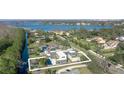 Aerial view of a modern house with pool, situated on a waterfront lot at 10424 Pocket Ln, Orlando, FL 32836