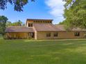 Contemporary brick and stucco home on a green lawn, featuring a clerestory window bank at 9525 Mcnorton Rd, Altamonte Springs, FL 32714