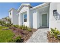 Close-up of the home's entrance, landscaping, and walkway leading to the front door at 2590 Cavanaugh Dr, Orlando, FL 32817