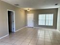 Bright living room with tile floors and neutral walls at 328 Chelmsford Ct, Kissimmee, FL 34758