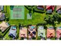 Aerial view of a neighborhood featuring a pool, tennis court, and basketball court at 9060 Heritage Bay Cir, Orlando, FL 32836