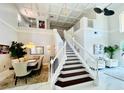 Bright foyer featuring high ceilings, staircase, dining area, and marble floors at 9060 Heritage Bay Cir, Orlando, FL 32836