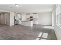 Open-concept kitchen featuring stainless steel appliances, a center island, granite counters, and tile floors at 1709 Forest Run Ln, Auburndale, FL 33823