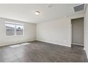 Bright and spacious living room features neutral paint, tile floors, recessed lighting, and large windows at 1709 Forest Run Ln, Auburndale, FL 33823