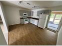 A kitchen with neutral cabinets, laminate countertops, white appliances, and wood-look flooring at 821 Savona Pl, Kissimmee, FL 34758