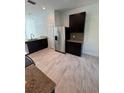 Contemporary kitchen featuring stainless steel refrigerator and appliances, granite countertops, and tile flooring at 1780 Converse Ct, Deltona, FL 32738