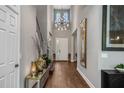 An inviting entryway features a soaring ceiling, modern lighting, and wood flooring, creating a grand entrance at 8300 Ludington Cir, Orlando, FL 32836
