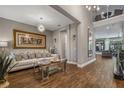 A bright and airy living room boasts elegant decor and plenty of natural light and an eye-catching chandelier at 8300 Ludington Cir, Orlando, FL 32836