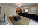 Living Room features a sectional sofa, ottoman, and ceiling fan at 9002 Majesty Palm Rd, Kissimmee, FL 34747