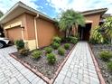 Well-maintained front garden and walkway leading to the entrance of this lovely home at 681 Coronado Dr, Kissimmee, FL 34759