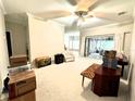 Spacious living room featuring ample space, neutral walls, and sliding glass doors to the lanai at 681 Coronado Dr, Kissimmee, FL 34759
