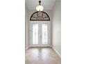 Elegant entryway with double doors and arched window detail at 729 San Raphael St, Kissimmee, FL 34759