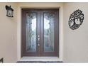 Double front doors with glass inserts and decorative metalwork at 729 San Raphael St, Kissimmee, FL 34759