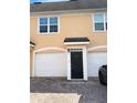 Attractive townhome featuring a private entrance, brick driveway, and attached garage for convenience at 3432 Westchester Square Blvd # 205, Orlando, FL 32835