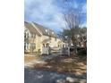 Charming townhome exterior featuring well-maintained landscaping, decorative fences, and inviting entrances at 3432 Westchester Square Blvd # 205, Orlando, FL 32835