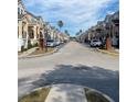 Inviting street view showcasing well-maintained townhomes, palm trees, and community charm at 3432 Westchester Square Blvd # 205, Orlando, FL 32835