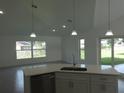 Modern kitchen with stainless steel appliances, a center island, and plenty of natural light at 531 Rhodes Dr, Deland, FL 32720