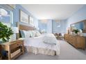 Bright bedroom with blue walls, natural light, and stylish furnishings at 2288 Sirena Ln, Mount Dora, FL 32757