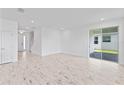 Spacious living room featuring tile floors, neutral paint, and sliding glass doors at 2288 Sirena Ln, Mount Dora, FL 32757