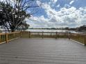 Expansive deck overlooking a tranquil lake, creating a serene and inviting outdoor space at 4808 Anderson Rd, Orlando, FL 32812