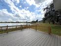 A spacious deck overlooks a serene lake, offering a perfect spot for relaxation and outdoor enjoyment at 4808 Anderson Rd, Orlando, FL 32812