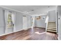 Bright living room with hardwood floors, modern lighting, and staircase at 6364 Lake Smith Cir, Windermere, FL 34786