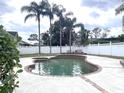 Irregular shaped pool with brick coping and a large backyard at 9524 Bay Vista Estates Blvd, Orlando, FL 32836