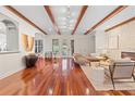 Spacious living room with hardwood floors, exposed beams, and a stone fireplace at 222 Acadia Ter, Celebration, FL 34747