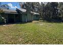 Mature backyard and home are awaiting renovations for the right homeowner at 1440 Walker Rd, Lakeland, FL 33810